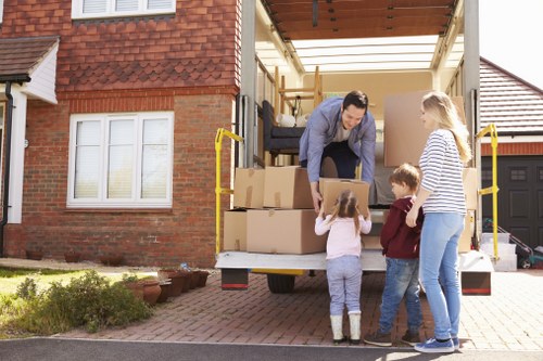 Local removals crew handling boxes and furniture in Pimlico