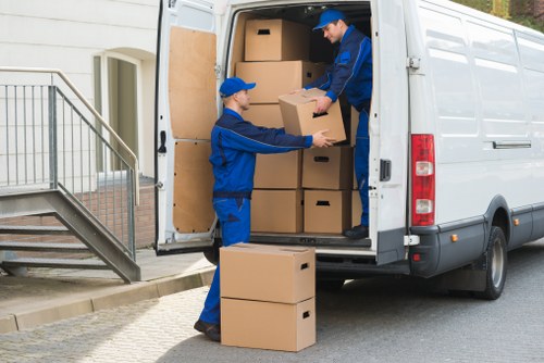 Professional team loading bulky furniture for pick-up in Pimlico