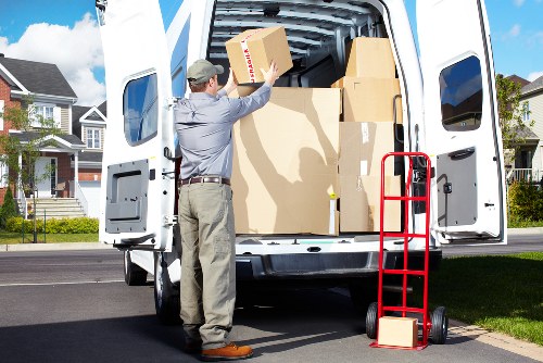 Staff assessing a removal item before carrying it through a doorway