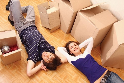 Expert movers handling boxes and furniture during a flat removal in Pimlico