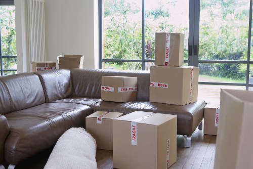 Removal team working carefully with boxes and furniture at the van